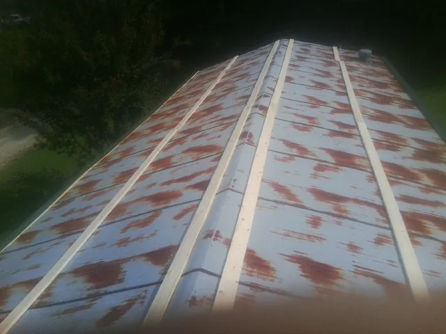 Rusted metal roof panels with new wood purlins before replacement — Storm Damage Roof Repair in Cheshire by Roofing Brothers